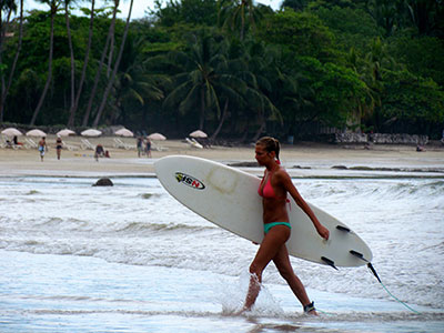 Costa rican surfer girl at beach