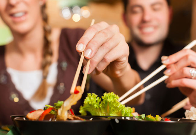 Man and woman eating in a restaurant