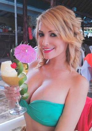 blonde Costa Rican lady looking refreshed in her cocktail