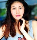 attractive Thai woman in a gray blouse