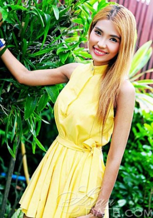 cute Thai babe in a sunny yellow dress