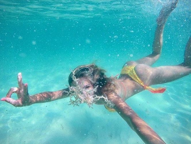 hot Colombian designer swimming underwater