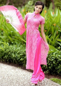 tantalizing Vietnam girl in a pink dress holding a pink fan