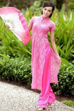 tantalizing Vietnam girl in a pink dress holding a pink fan