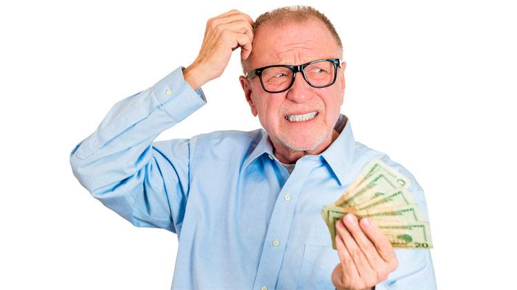 worried old man holding money