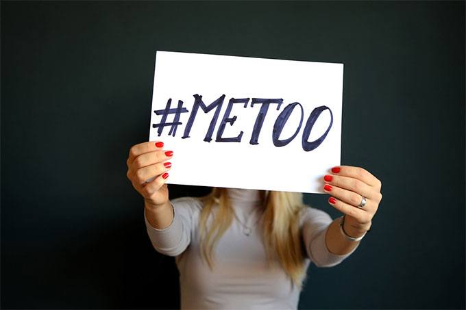 a girl holding a #MeToo banner