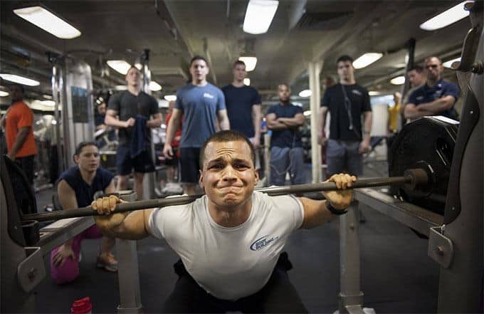 man struggling in the barbell