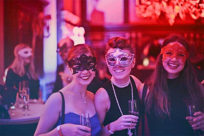 women in a masquerade bar