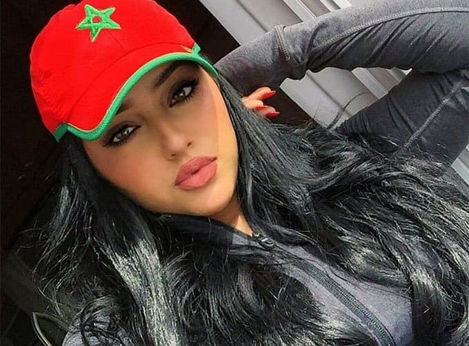 beautiful Moroccan woman wearing a cap with flag symbol