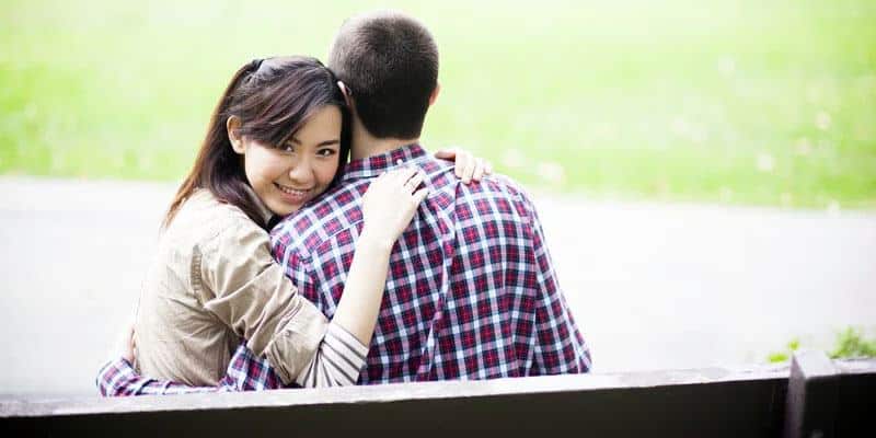 cute and sweet Asian girl hugging her partner