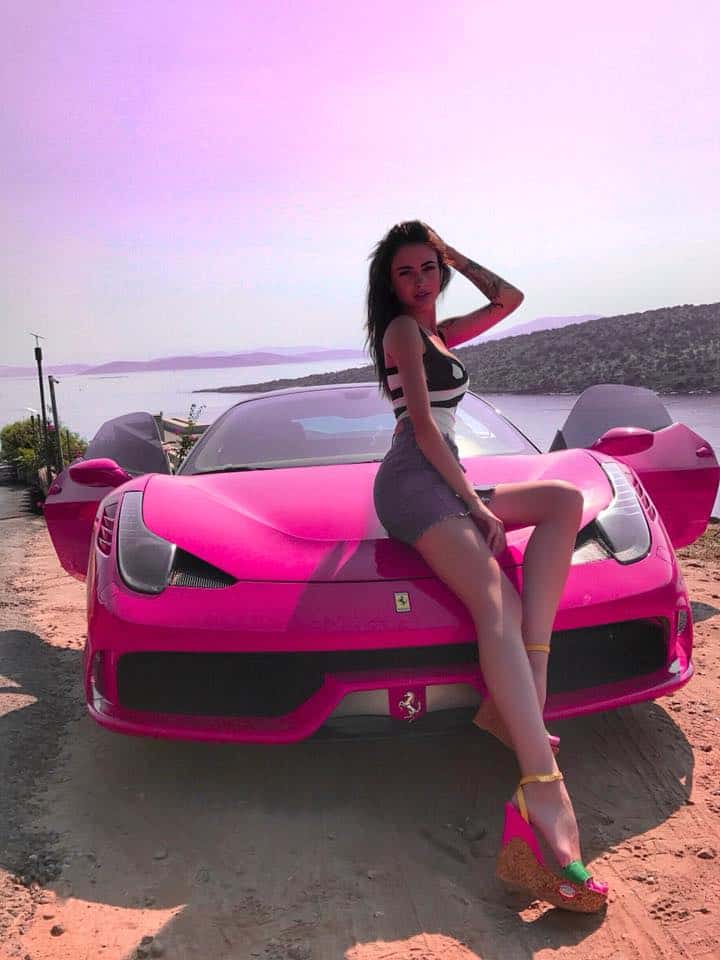 Kristina Stoloka in front of a pink car