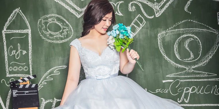 happy Asian bride smelling flowers