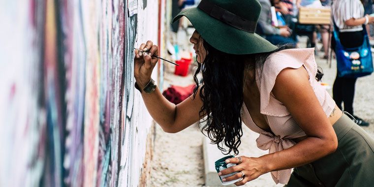 woman painting on the wall