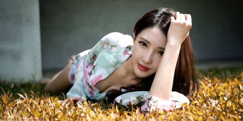 Chinese woman having a pictorial on the grass