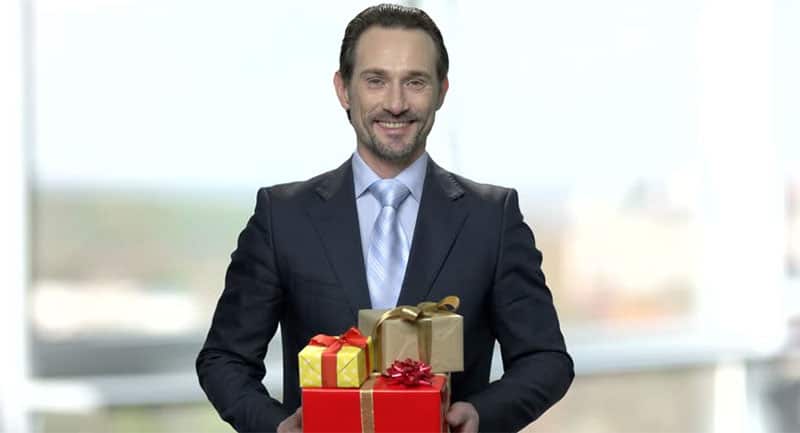 middle aged man holding gifts