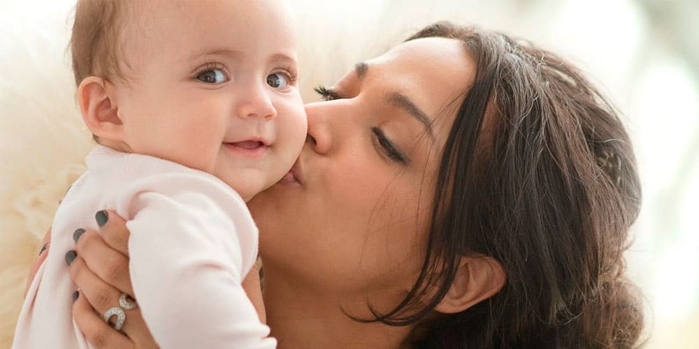 Argentina mother kissing her baby