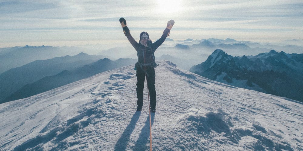 woman on top of a snowy mountain