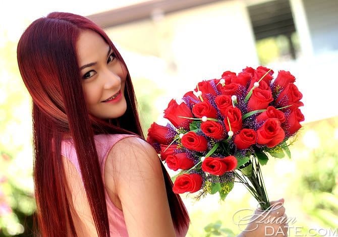 beautiful Filipina holding a bouquet of flowers