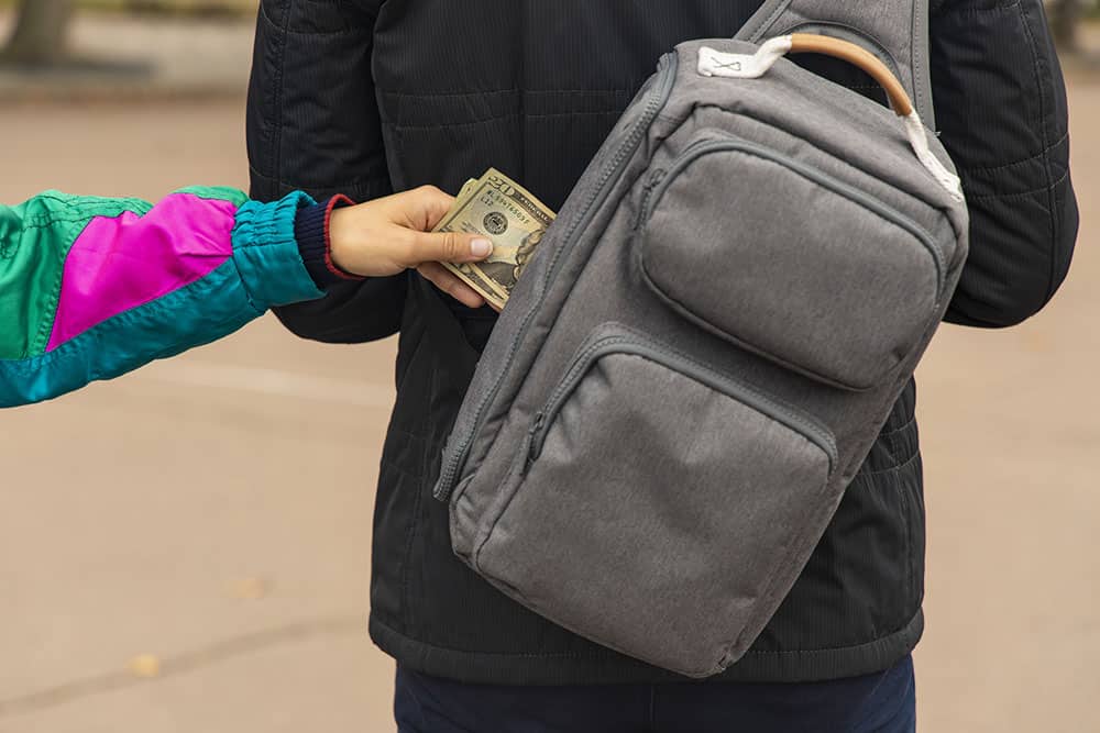 pickpocketing a tourist backpack